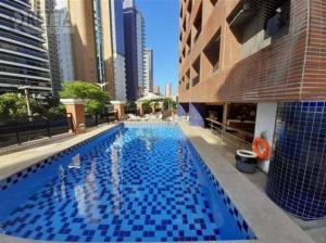 a large swimming pool in a city with tall buildings at Localização Perfeita, Hotel, Completo, Limp.Diária in Fortaleza