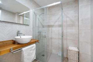 a bathroom with a sink and a glass shower at Ancha 9 in Sanlúcar de Barrameda +19 photos