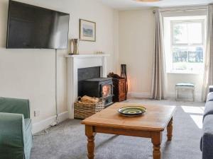 a living room with a coffee table and a fireplace at Blackloch in Gatehouse of Fleet