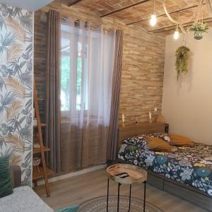 a bedroom with a bed and a large window at Charmant logement dans une ancienne ferme in Provins