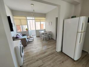 a kitchen and living room with a white refrigerator at Frezia House in Kalamaki Chanion