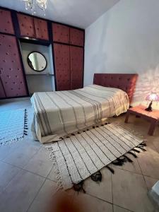 シディ・ブ・サイドにあるLa maisonnetteのベッドルーム1室(ベッド1台、ラグ、テーブル付)