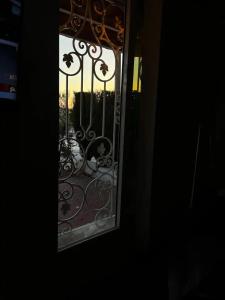 a view of a window with a view of a gate at La maisonnette in Sidi Bou Saïd