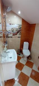 a bathroom with a toilet and a sink at Къща за гости Джамбазови in Sarnitsa