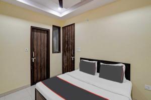 - une chambre avec un grand lit dans l'établissement Capital O Mt Corporate Stays Near Iskcon Temple Noida, à Indirapuram