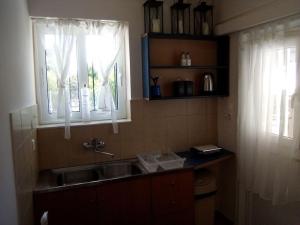 a kitchen with a sink and a window at THSTUDIOS Its the best in Faraí +32 photos