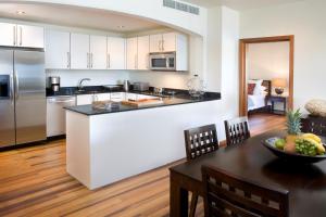 a kitchen with a counter top and a dining table at Residences at Nonsuch Bay Antigua - Room Only - Self Catering in Saint Philips