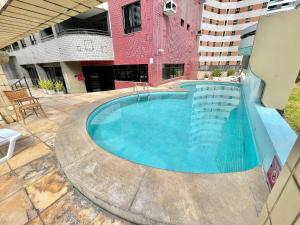 a large swimming pool in the middle of a building at Flat no Saint Martin in Fortaleza