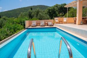 a swimming pool with a view of a mountain at Villa Apollo up to 8px, private pool in Fiskardho