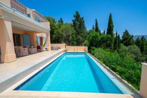 a swimming pool in the backyard of a house at Villa Apollo up to 8px, private pool in Fiskardho