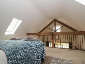 a bedroom with a bed with two towels on it at Bullamoor Barn in Northallerton