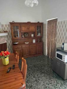 cocina con mesa de madera y microondas en Girasole, en Trepuzzi