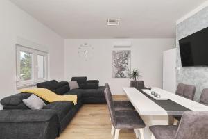 a living room with a couch and a table at Maslenica in Maslenica