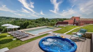 a hot tub on a deck next to a swimming pool at VILLA SUMAC 6, Emma Villas in Sortino