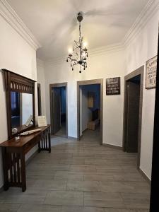 a hallway with a table and a chandelier at Flats Puente Ademuz Apartamento de 3 habitaciones in Valencia