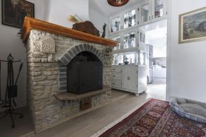 a living room with a stone fireplace in a house at R&J's Home in Bihać