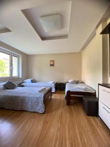a bedroom with two beds and a television in it at Dolores in Giżycko