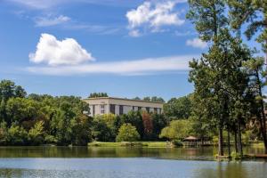 a building with a lake in front of it at Hampton Inn Columbia I-26/Harbison Blvd in Columbia