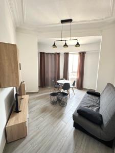 a living room with a couch and a table at Flats Puente Ademuz Apartamento de 3 habitaciones in Valencia