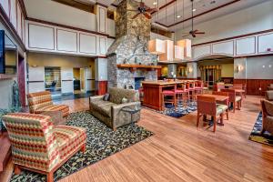 a lobby with chairs and tables and a stone fireplace at Hampton Inn & Suites Cashiers - Sapphire Valley in Sapphire
