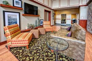 Sapphire的住宿－喀什爾藍寶石谷漢普頓套房酒店，客厅配有沙发、椅子和桌子