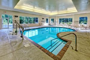 a pool in a hotel with chairs and tables at Hampton Inn & Suites Cashiers - Sapphire Valley in Sapphire