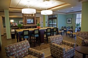 a restaurant with tables and chairs in a room at Hampton Inn Colby in Colby