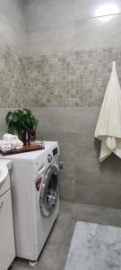 a washer and dryer in a bathroom at BAYHOUSE - Апартаменты в ЖК Уш Сункар in Almaty