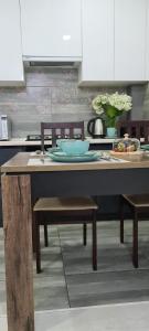a table in a kitchen with a table and chairs at BAYHOUSE - Апартаменты в ЖК Уш Сункар in Almaty
