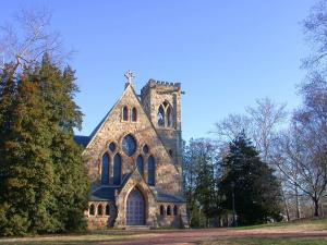 una vecchia chiesa di pietra con una croce sopra. di Hampton Inn Charlottesville a Charlottesville