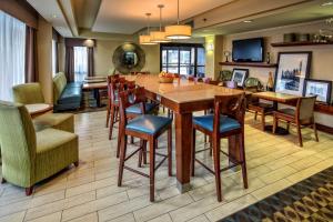 a dining room with a large table and chairs at Hampton Inn Charlottesville in Charlottesville