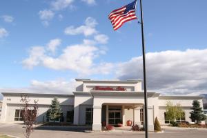 an american flag flying in front of a building at Hampton Inn Cedar City in Cedar City