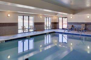 a large swimming pool with chairs and tables at Hampton Inn Chickasha in Chickasha