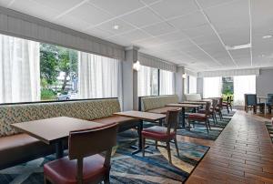 a row of tables and chairs in a restaurant at Hampton Inn Patriots Point in Charleston