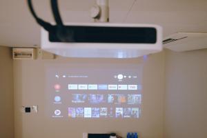 a projector hanging from the ceiling of a room at Rest Bugis Hotel in Singapore