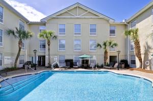 a pool in front of a building with palm trees at Hampton Inn & Suites Charleston/Mt. Pleasant-Isle Of Palms in Charleston