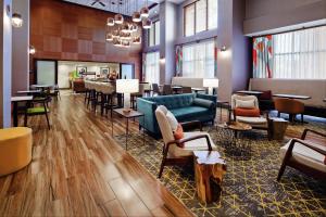 a lobby of a hotel with tables and chairs at Hampton Inn & Suites Chino Hills in Chino Hills