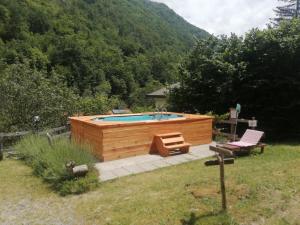 a swimming pool in a yard next to a mountain at Borgo Don Camillo in Cutigliano
