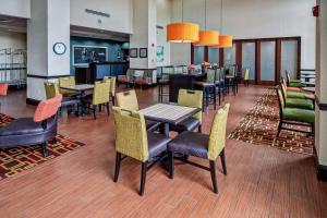 a restaurant with tables and chairs and a dining room at Hampton Inn & Suites Clarksville in Clarksville