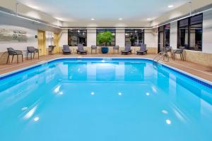 a pool in a hotel with chairs and tables at Hampton Inn Clarion in Clarion