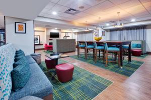 a waiting room with a long table and chairs at Hampton Inn Clarion in Clarion