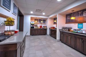 a large kitchen with wooden cabinets in a restaurant at Hampton Inn Clarion in Clarion