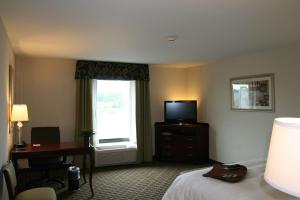 a hotel room with a bed and a desk and a window at Hampton Inn & Suites Cleveland-Mentor in Mentor