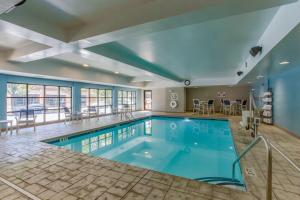 a large swimming pool in a hotel room with a pool at Homewood Suites by Hilton Davidson in Davidson