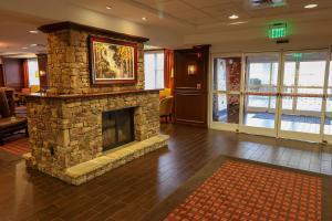 a lobby with a stone fireplace in a hotel room at Hampton Inn Lincolnton in Lincolnton