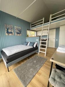 a bedroom with a bunk bed and a ladder at Amma Jóna in Hvolsvöllur