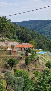 una casa en la cima de una colina con piscina en CASA DO SOL , Turismo Rural, en Celorico de Basto