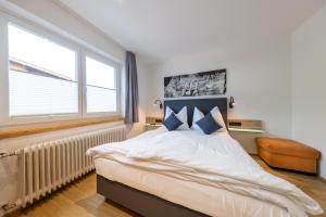 a bedroom with a bed and a large window at Appart-Pension Schnöll in Mittersill