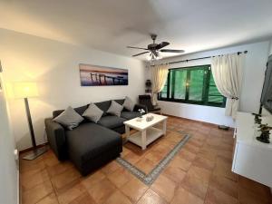 a living room with a couch and a table at The Sallies - 3 bedroom villa with private pool in Tías