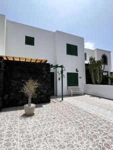 a building with a potted plant in a courtyard at The Sallies - 3 bedroom villa with private pool in Tías